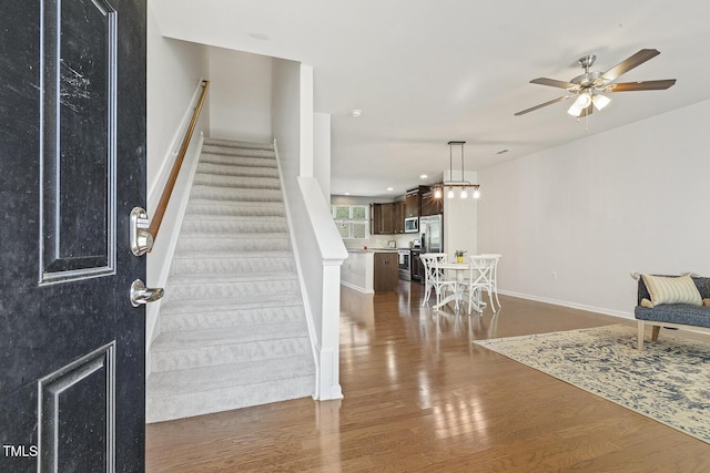 2027 Hayes Ln, Holly Springs, NC 27540 - foyer entrance featuring dark wood-type flooring, a ceiling fan, stairway, and baseboards