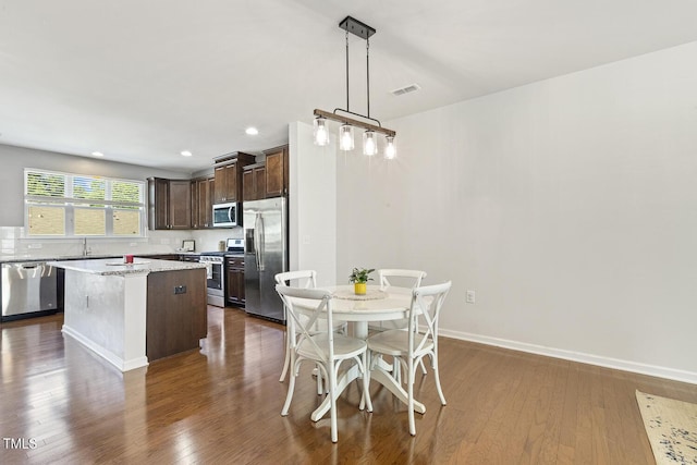 2027 Hayes Ln, Holly Springs, NC 27540 - dining area with dark wood-type flooring, recessed lighting, and baseboards