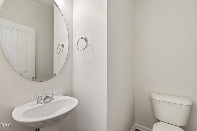 2027 Hayes Ln, Holly Springs, NC 27540 - half bath featuring a sink and toilet