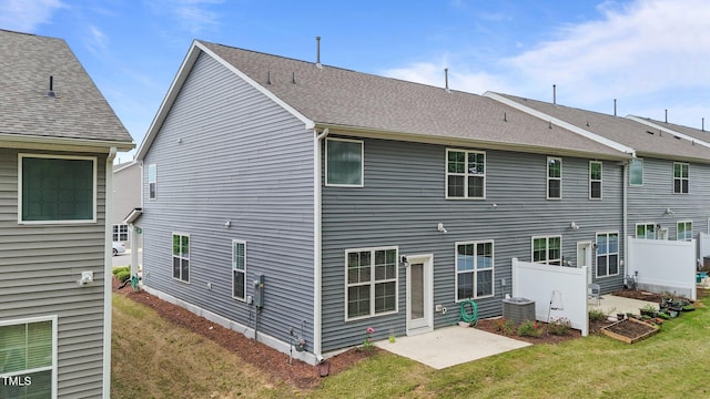 2211 Cherry Top Dr, Fuquay Varina, NC 27526 - rear view of house with central air condition unit, a lawn, fence, and a patio area