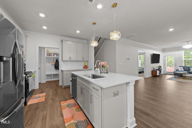 2211 Cherry Top Dr, Fuquay Varina, NC 27526 - kitchen featuring crown molding, open floor plan, a sink, dark wood finished floors, and stainless steel appliances