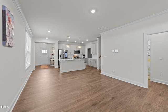 2211 Cherry Top Dr, Fuquay Varina, NC 27526 - unfurnished living room with recessed lighting, baseboards, ornamental molding, and wood finished floors