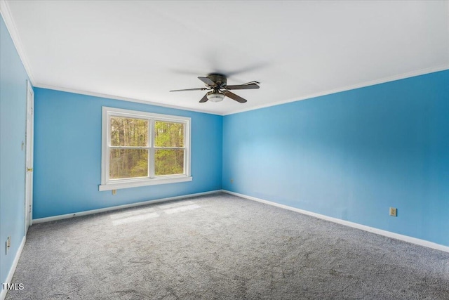 carpeted spare room with ornamental molding, ceiling fan, and baseboards
