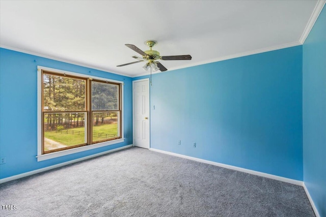 spare room featuring carpet, baseboards, ornamental molding, and ceiling fan