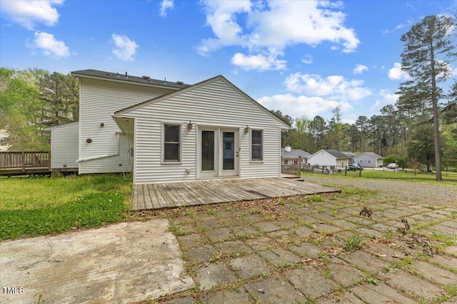 rear view of property featuring a wooden deck