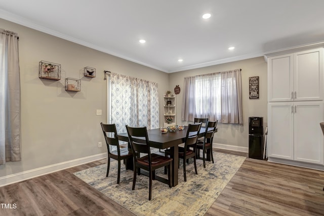 dining area featuring wood finished floors, baseboards, ornamental molding, and recessed lighting