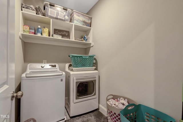 laundry area with washer and clothes dryer, laundry area, and baseboards