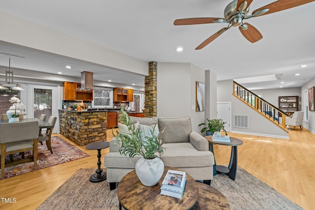 1509 Cumberland Rd, Chapel Hill, NC 27514 - living room featuring visible vents, light wood finished floors, ceiling fan, and stairs