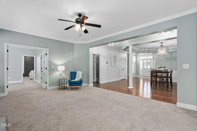 sitting room with baseboards, carpet flooring, decorative columns, and a ceiling fan