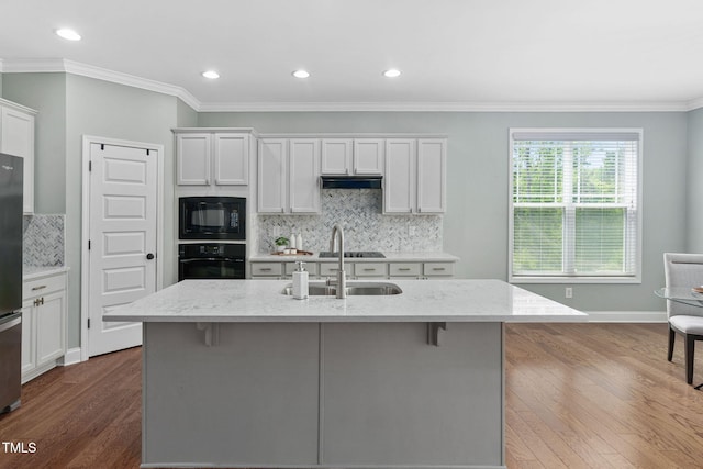 kitchen with crown molding, white cabinets, dark wood finished floors, decorative backsplash, and black appliances