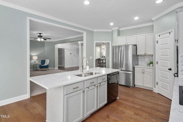 kitchen featuring a sink, freestanding refrigerator, black dishwasher, recessed lighting, and white cabinetry