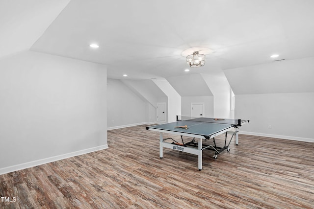 rec room with baseboards, recessed lighting, wood finished floors, and vaulted ceiling