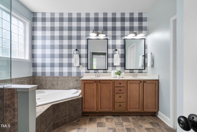 bathroom featuring wallpapered walls and a sink
