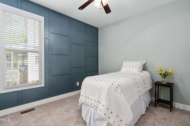 bedroom with light colored carpet, baseboards, visible vents, and multiple windows