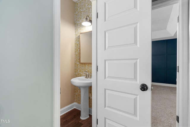 bathroom featuring a sink, baseboards, and wood finished floors