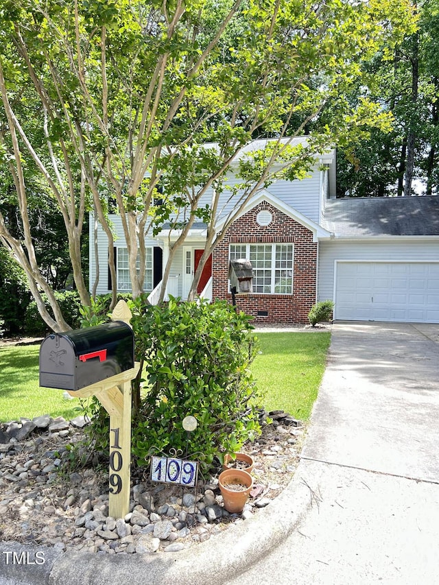 109 Elmview Dr, Cary, NC 27519 - obstructed view of property with brick siding, an attached garage, concrete driveway, and a front lawn