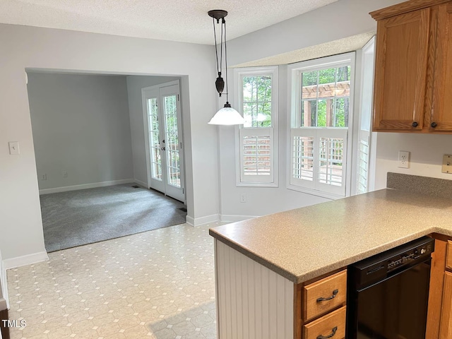 109 Elmview Dr, Cary, NC 27519 - kitchen featuring black dishwasher, brown cabinetry, baseboards, pendant lighting, and a textured ceiling