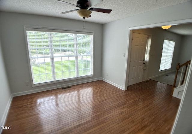 109 Elmview Dr, Cary, NC 27519 - spare room with wood finished floors, a textured ceiling, ceiling fan, baseboards, and plenty of natural light