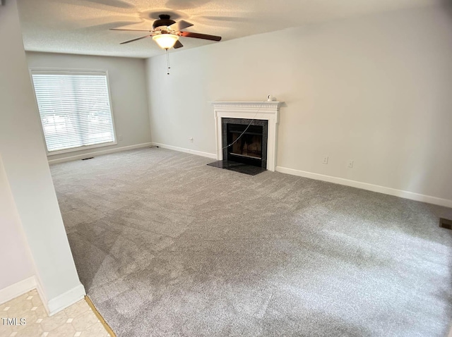 109 Elmview Dr, Cary, NC 27519 - unfurnished living room with a premium fireplace, a ceiling fan, light carpet, baseboards, and a textured ceiling