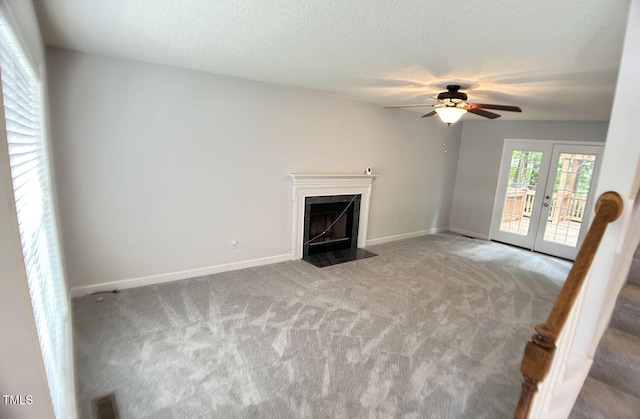 109 Elmview Dr, Cary, NC 27519 - unfurnished living room with carpet, ceiling fan, baseboards, a high end fireplace, and french doors
