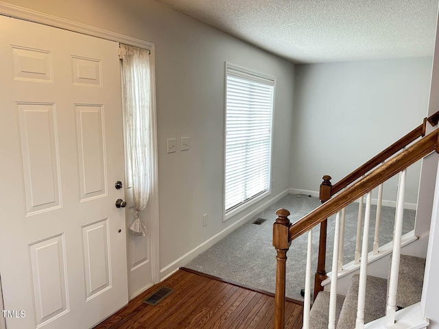 109 Elmview Dr, Cary, NC 27519 - foyer entrance featuring wood finished floors, baseboards, stairs, and a textured ceiling