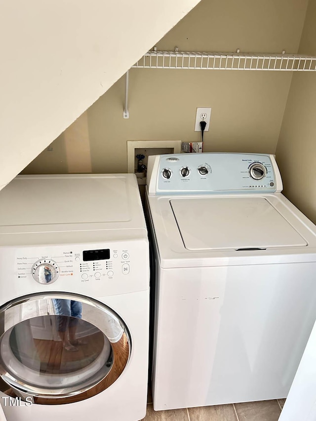 109 Elmview Dr, Cary, NC 27519 - laundry area with washer and dryer and light tile patterned flooring