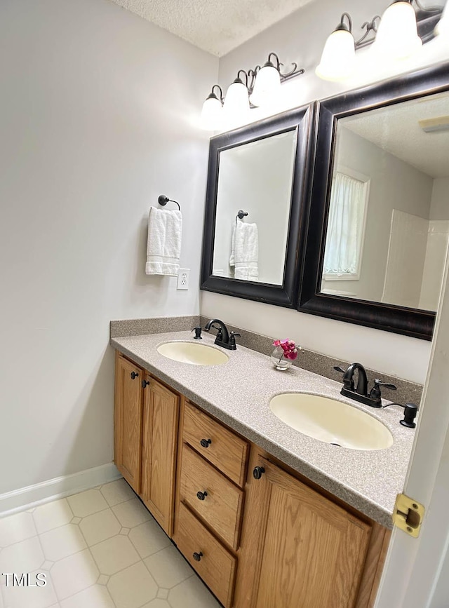 109 Elmview Dr, Cary, NC 27519 - bathroom with double vanity and a textured ceiling