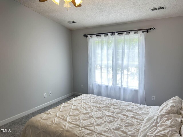 109 Elmview Dr, Cary, NC 27519 - carpeted bedroom with a textured ceiling, baseboards, and ceiling fan