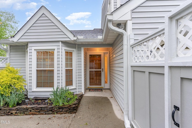 entrance to property with roof with shingles