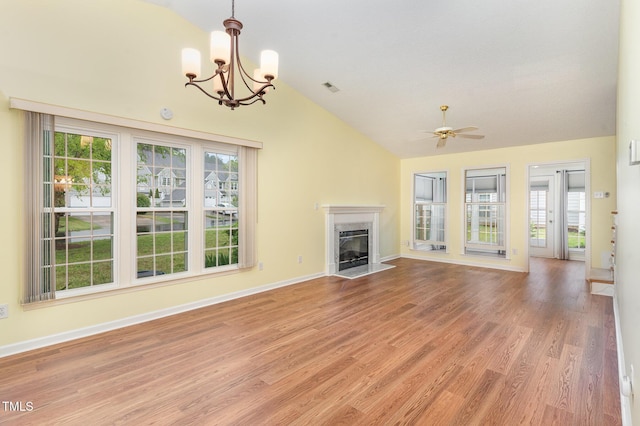 unfurnished living room featuring lofted ceiling, a healthy amount of sunlight, light wood finished floors, and visible vents
