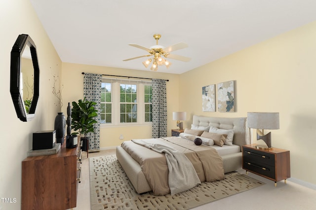 carpeted bedroom featuring baseboards and ceiling fan