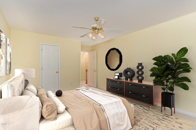 bedroom with a ceiling fan and baseboards