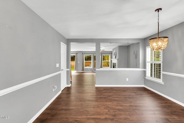 105 Ryder Cup Cir, Raleigh, NC 27603 - unfurnished living room featuring a chandelier, dark wood-style floors, and baseboards
