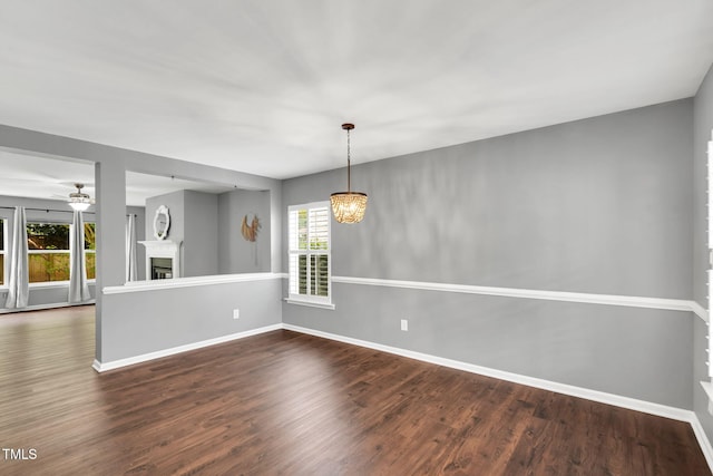 105 Ryder Cup Cir, Raleigh, NC 27603 - unfurnished living room with wood finished floors, a fireplace, baseboards, and a chandelier