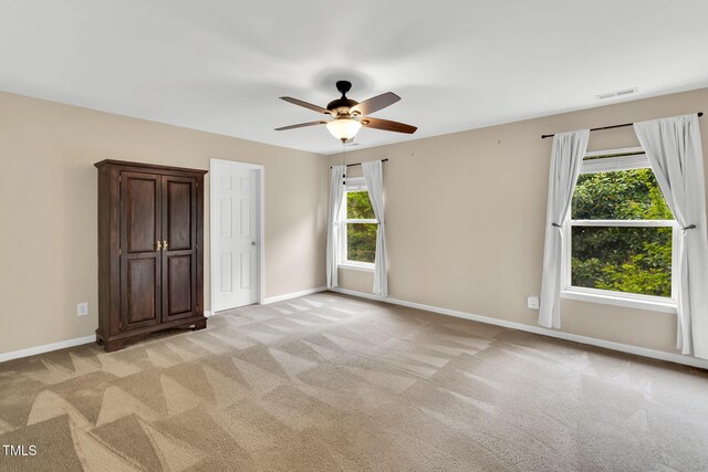 105 Ryder Cup Cir, Raleigh, NC 27603 - unfurnished bedroom with light carpet, baseboards, and a ceiling fan