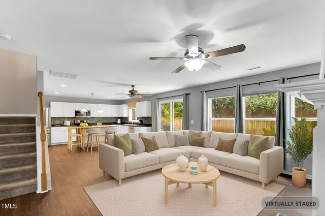 105 Ryder Cup Cir, Raleigh, NC 27603 - living area with stairs, ceiling fan, wood finished floors, and recessed lighting