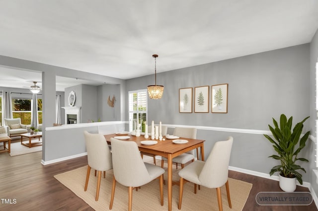 105 Ryder Cup Cir, Raleigh, NC 27603 - dining room with wood finished floors, baseboards, a fireplace, and ceiling fan