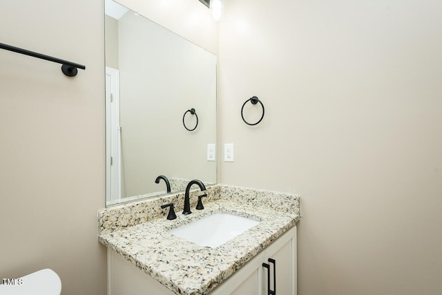 half bathroom featuring toilet and vanity