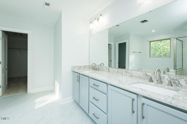 full bathroom with double vanity, visible vents, and a sink