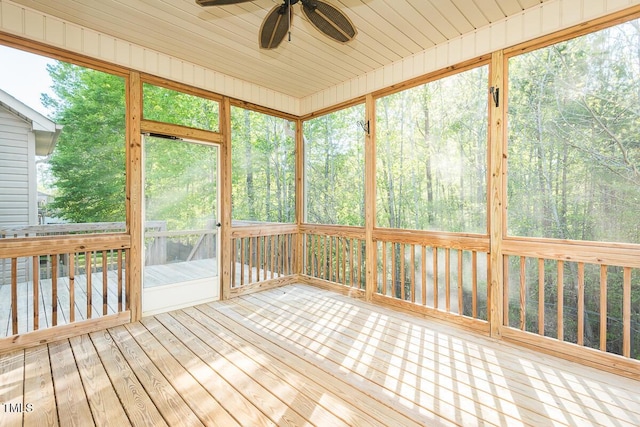 unfurnished sunroom featuring ceiling fan