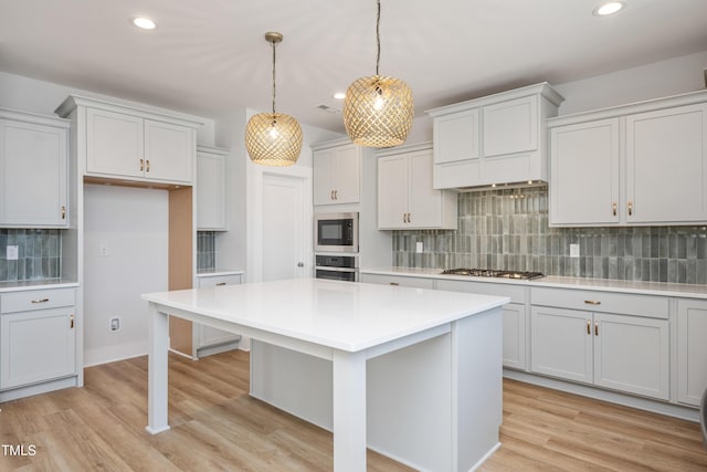 kitchen featuring decorative backsplash, light countertops, recessed lighting, and stainless steel appliances