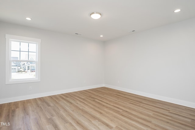 unfurnished room featuring visible vents, light wood-style flooring, recessed lighting, and baseboards