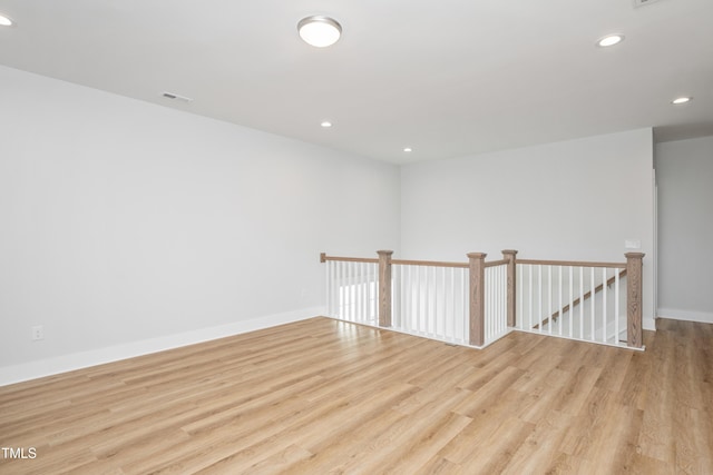 unfurnished room with light wood finished floors, baseboards, visible vents, and recessed lighting