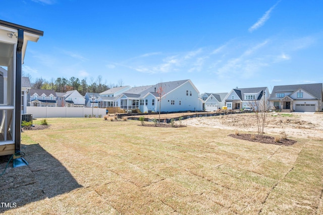 view of yard with a residential view and fence
