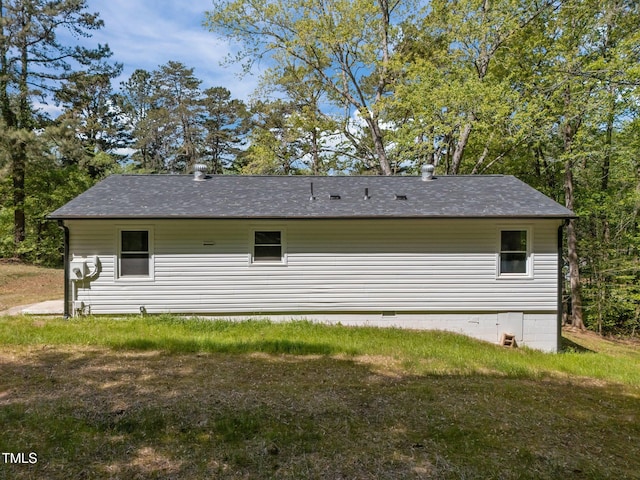 rear view of property featuring a shingled roof