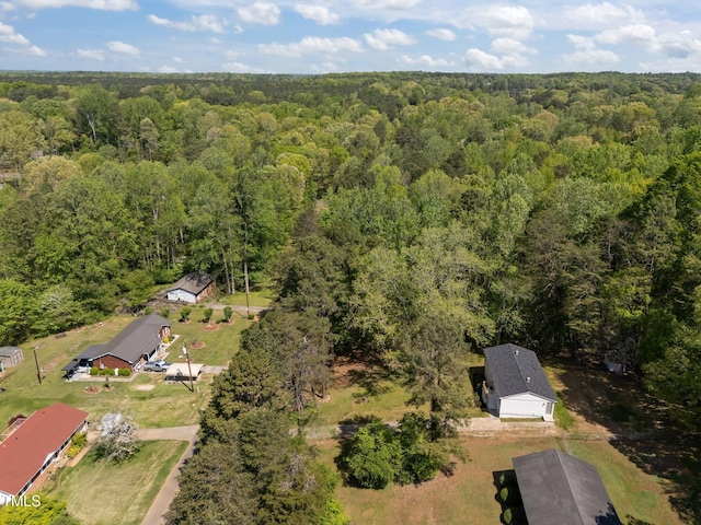 birds eye view of property featuring a forest view