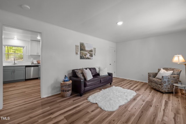 living area with baseboards and light wood finished floors