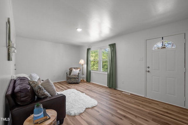 entrance foyer featuring wood finished floors, visible vents, and baseboards