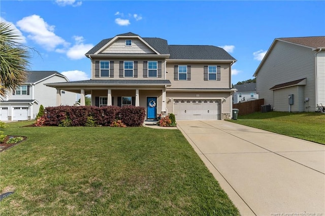 craftsman-style home featuring a garage, driveway, fence, and a front lawn