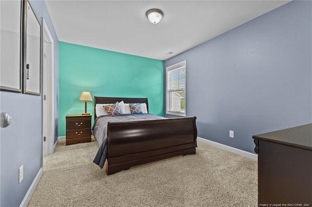 bedroom with carpet, visible vents, and baseboards